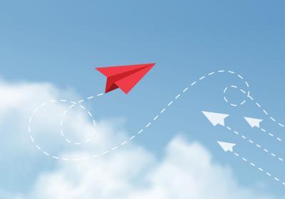 Illustration of paper airplanes, three going in one direction and a fourth going in a different one