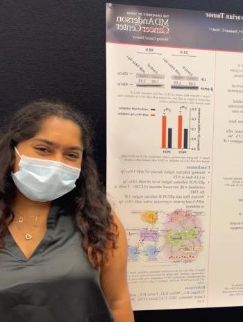 Anam Rawoof in front of her research poster
