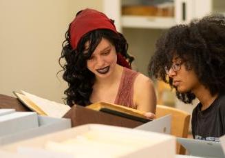 Swarthmore student Shayla Smith and Wynter Douglas '19 (from left) examine documents from Bryn Mawr's Special Collections.
