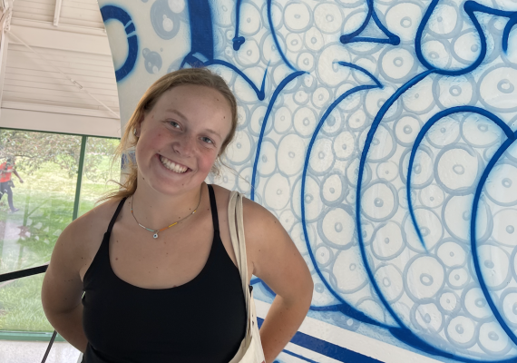 Claire Ford in front of a mural.