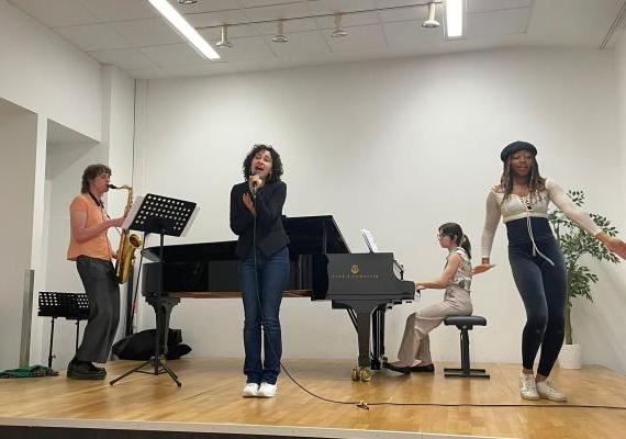 Jade Poli '25 rehearsing with other interns before their performance at the festival