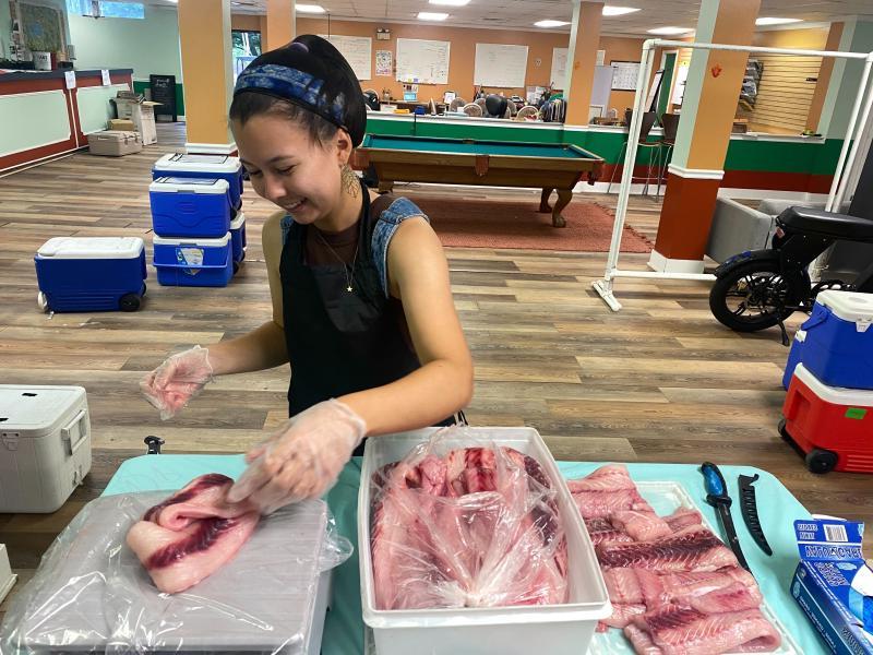 Amy Tse filleting fish