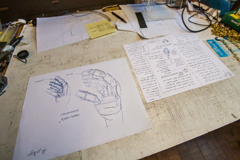 drawings of a robotic hand on a table